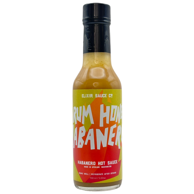 Bottle of Rum Hon Habanero hot sauce on a white background