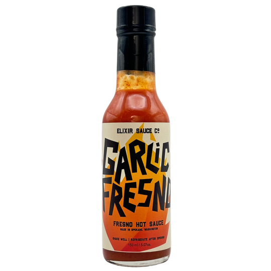 Bottle of Garlic Fresno hot sauce from Elixir Sauce Co. on a white background