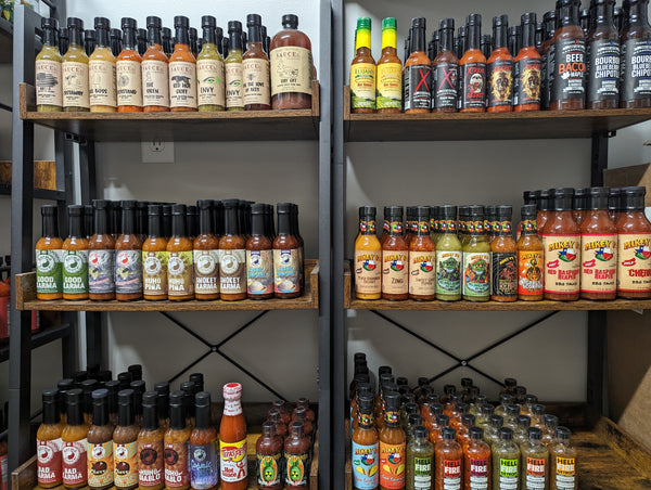 SCOVILLED stockroom shelves lined with craft hot sauce bottles