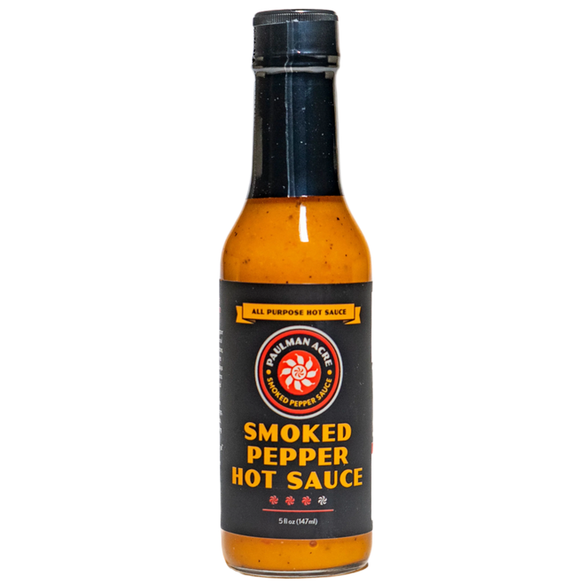 Bottle of smoked pepper hot sauce on a white background